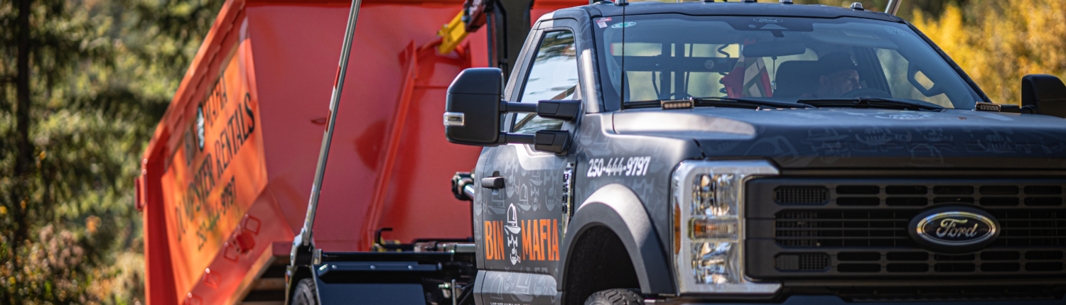 Bin Mafia close up photo of Ford 600 truck and orange bin in half released to ground position